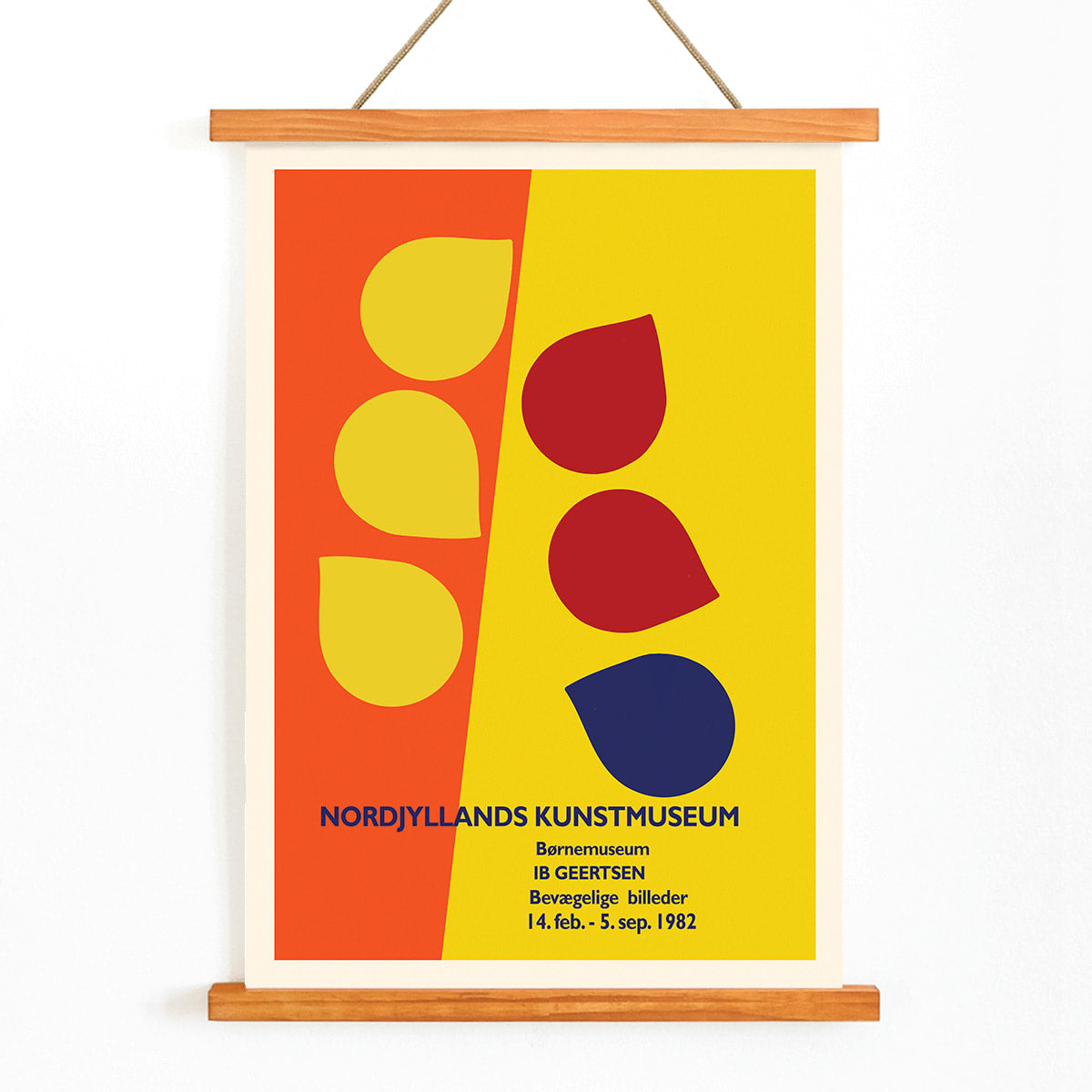 Exhibition poster by Ib Geertsen with colorful geometric shapes in yellow red and blue on an orange and yellow background, with wooden magnetic frame on white background