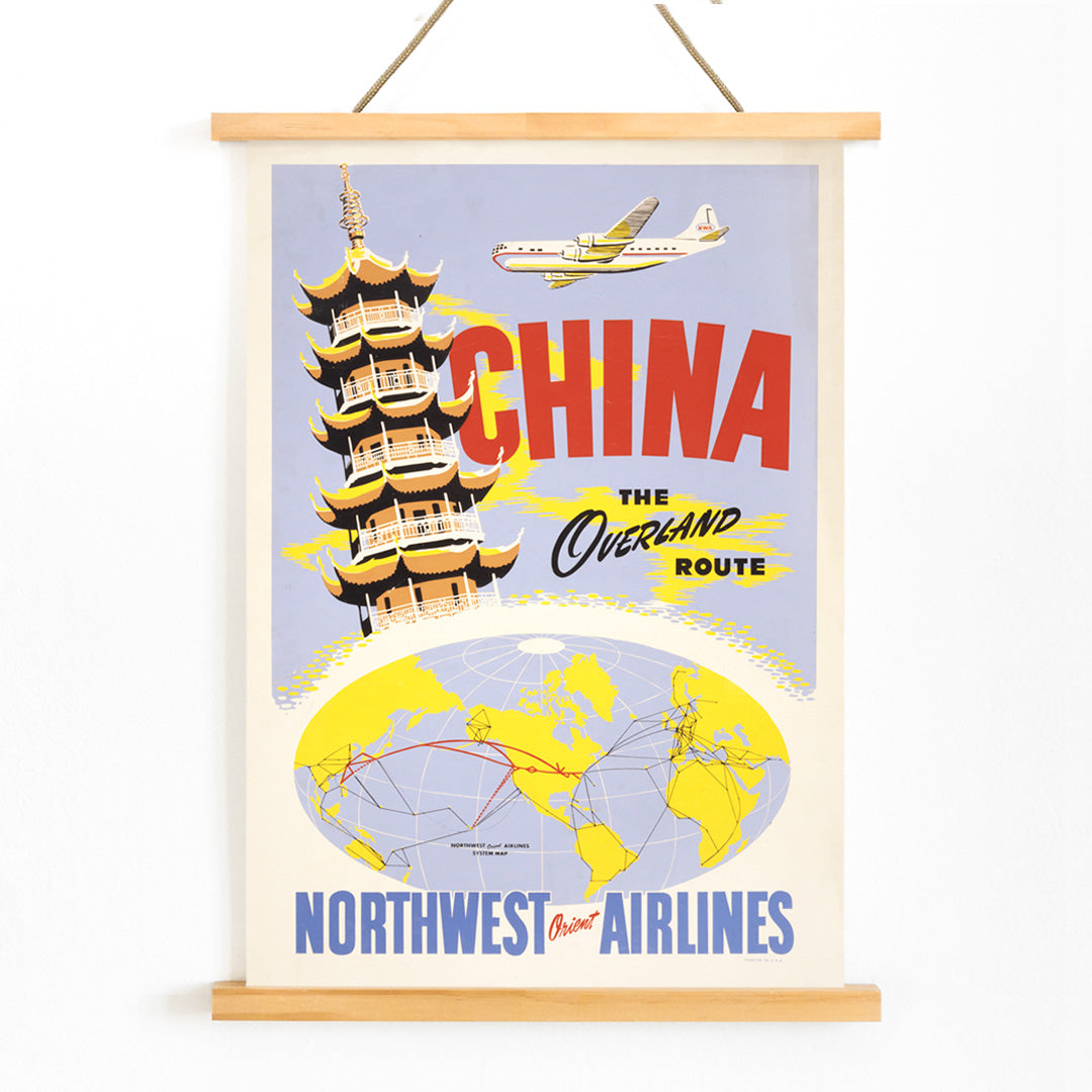 Vintage travel poster of China featuring a pagoda airplane and world map promoting the overland route by Northwest Orient Airlines, with wooden magnetic frame on white background