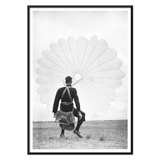 Air force parachuter landing and standing with deployed parachute by Ray Olsen poster, with black aluminium frame on white background