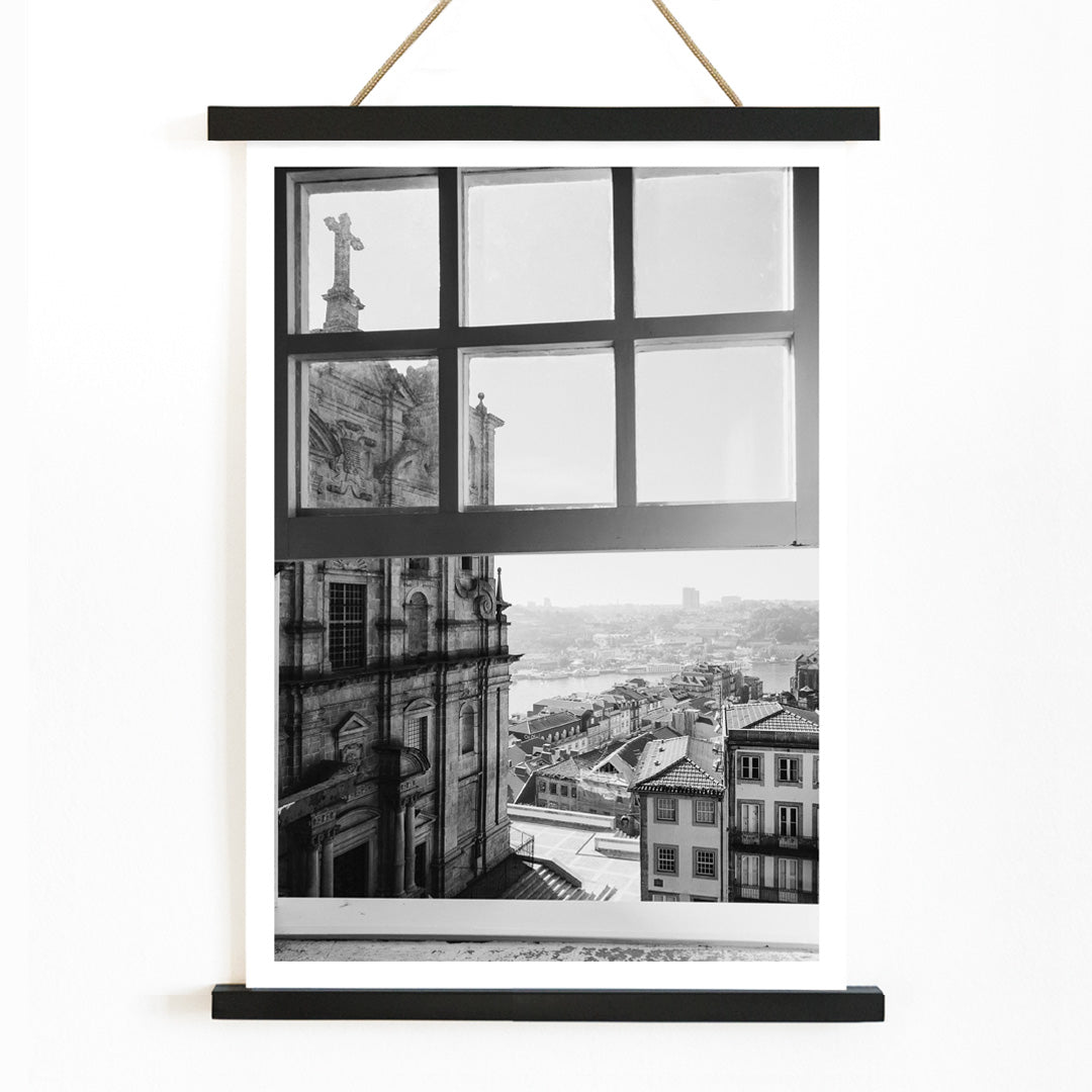 Black and white cityscape poster of Porto seen through a window from the artwork Porto from window, with wooden magnetic frame on white background