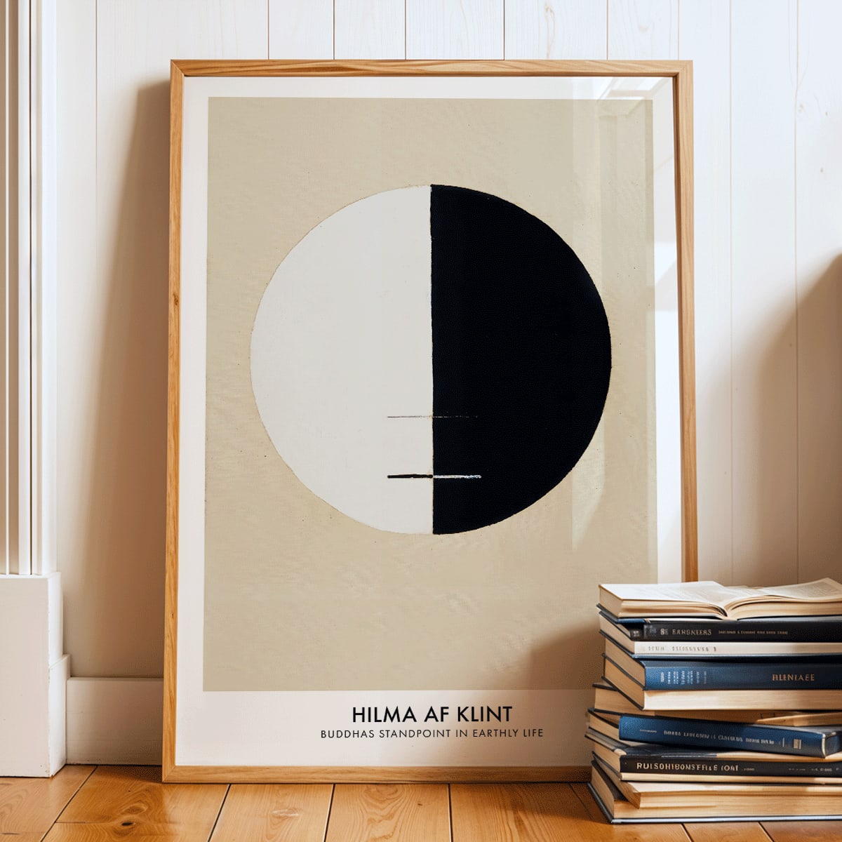Black and white circle artwork poster Buddha Standpoint In Early Life by Hilma AF Klint with divided circle on beige background, framed and displayed in modern living room decor
