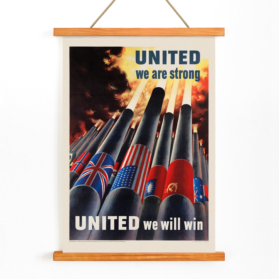 Allied nation flags on artillery cannons in fiery sky with text United we are strong United we will win by Henry Koerner, with wooden magnetic frame on white background