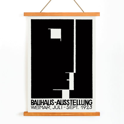 Black and white geometric abstract Bauhaus artwork by Joost Schmidt and László Moholy-Nagy featuring poster design with abstract shapes, with wooden magnetic frame on white background