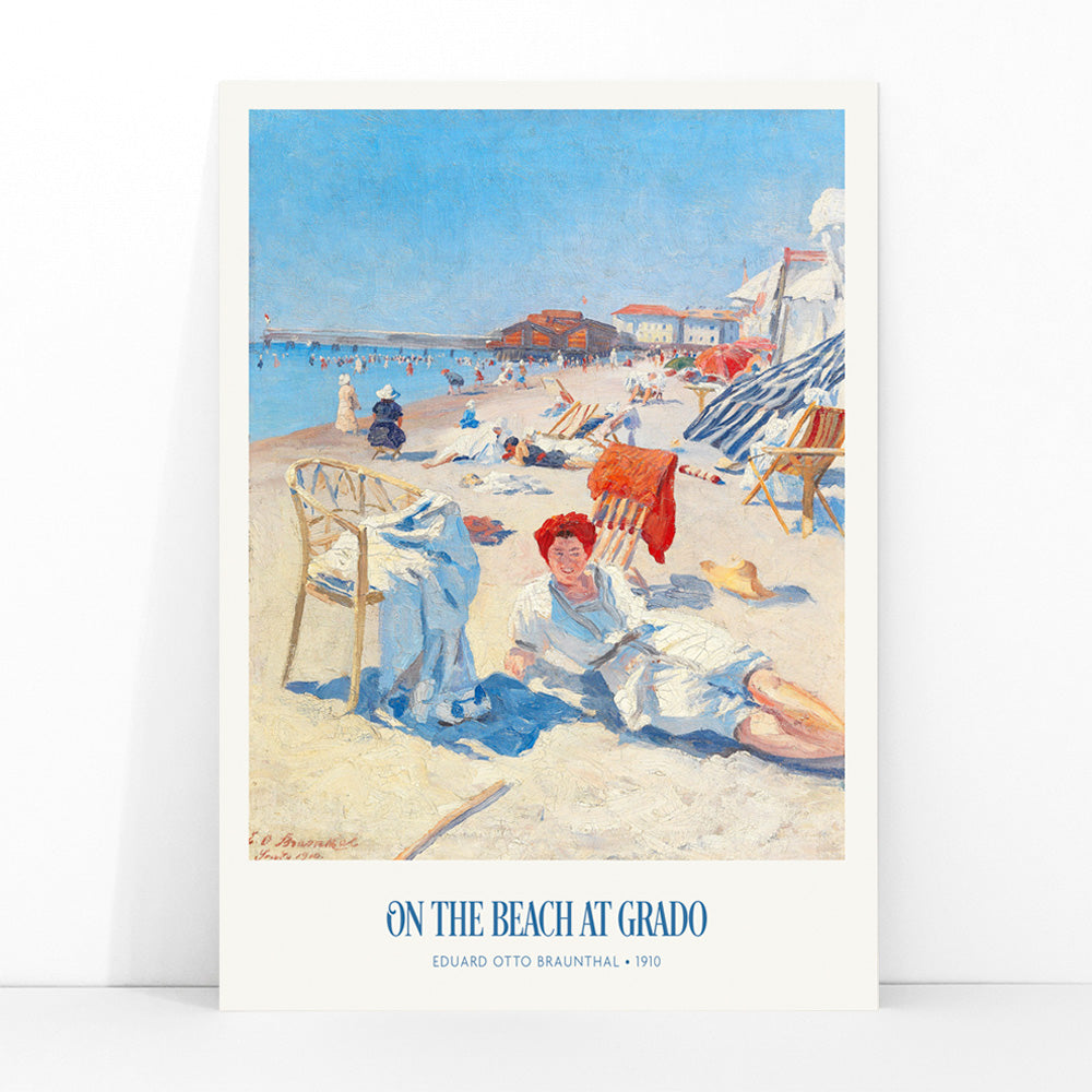 People relaxing on a sunny beach with chairs buildings and colorful umbrellas On the Beach at Grado by Eduard Otto Braunthal, framed and displayed in modern living room decor
