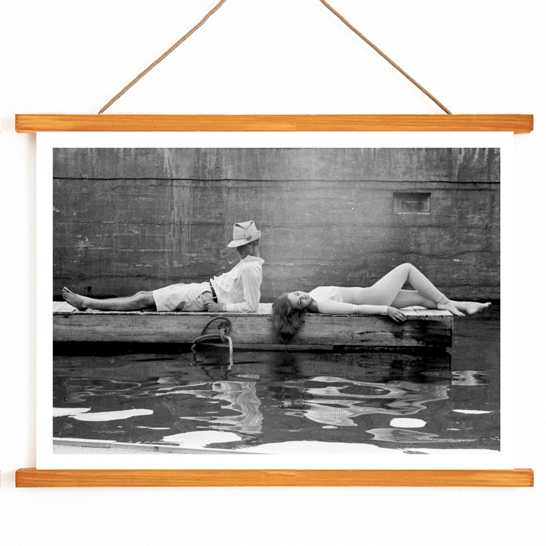 Marquess of Tavistock Henry Robin Ian Russell and Henrietta Tiarks relaxing on a dock in Bermuda by Toni Frissell poster, with wooden magnetic frame on white background