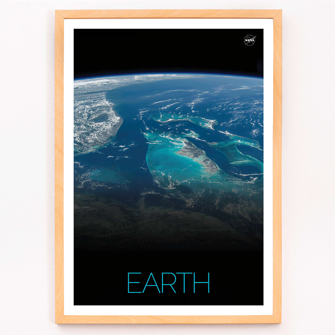 Earth from Space 2 by NASA showing a stunning satellite image of blue oceans continents and clouds, framed and displayed in modern living room decor