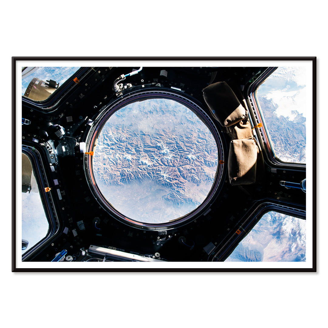 Earth view from International Space Station cupola by NASA with planet visible below poster artwork, with black aluminium frame on white background