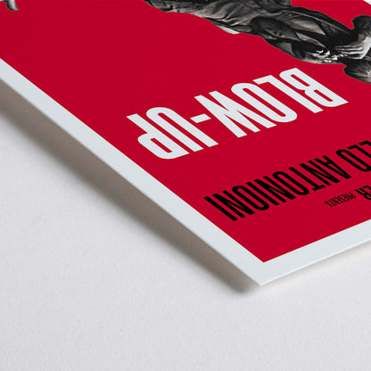 Closeup detail of Michelangelo Antonioni Blow Up Movie poster with dramatic black and white photography and vibrant red background