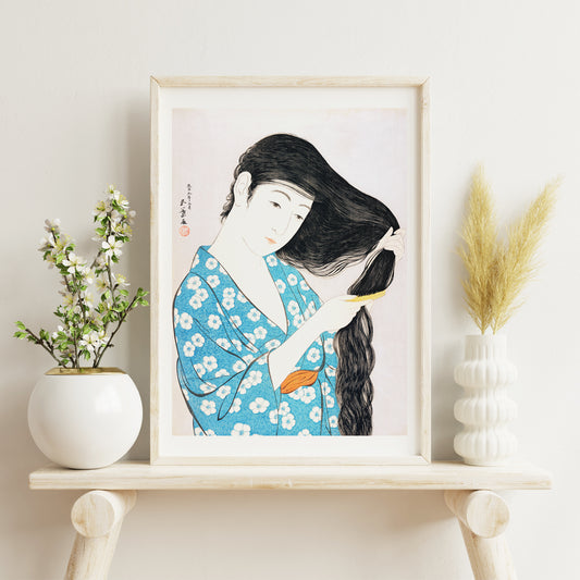 Woman in blue floral kimono combing her long hair artwork Woman Combing Her Hair by Goyo Hashiguchi Japanese art poster, framed and displayed in home decor