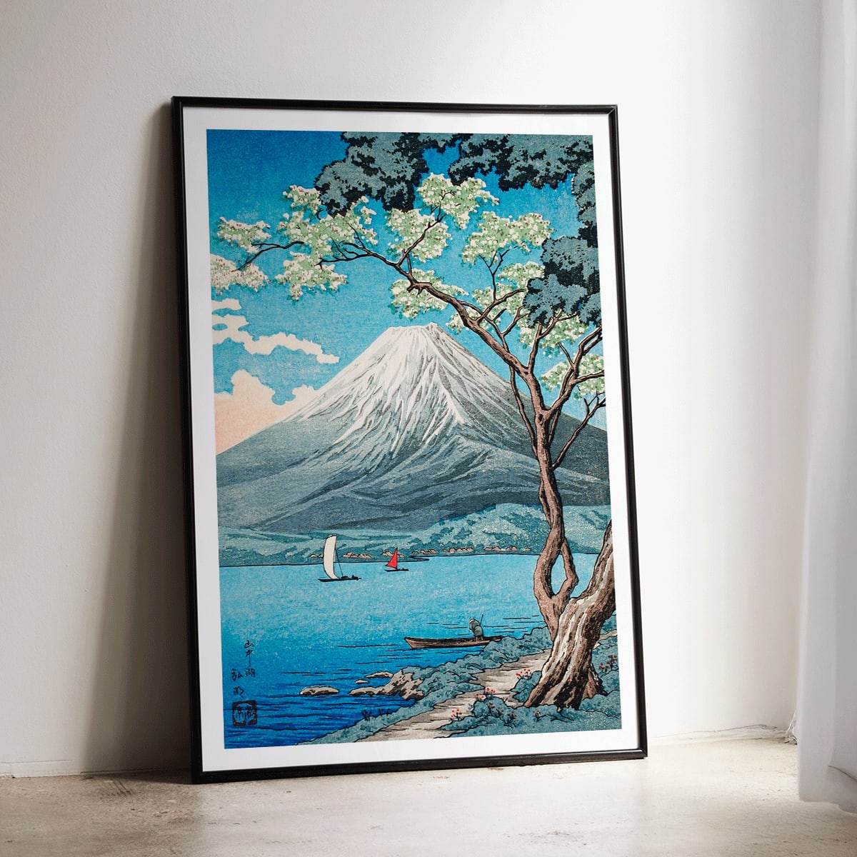 Mount Fuji from Lake Yamanaka by Hiroaki Takahashi with sailboats blue water and a tree in the foreground Japanese artwork poster, framed and displayed in modern living room decor