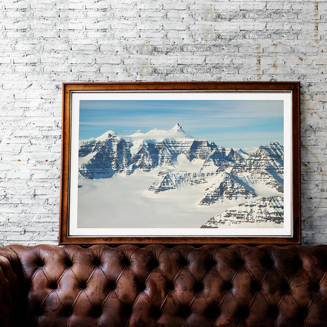 Snow covered mountain ridges and unique geology of the Geikie Plateau eastern Greenland by NASA poster, framed and displayed in home decor