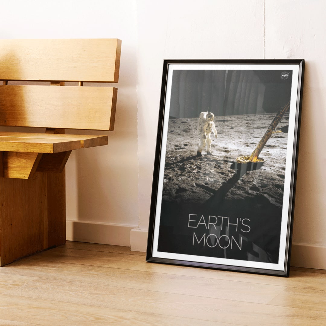 Astronaut on the lunar surface with text Earths Moon Man on Moon 2 by NASA poster, framed and displayed in home decor