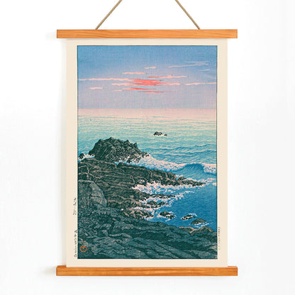 Morning at Cape Inubo by Kawase Hasui seascape with waves crashing on rocky shore at sunrise coastal scene poster, with wooden magnetic frame on white background