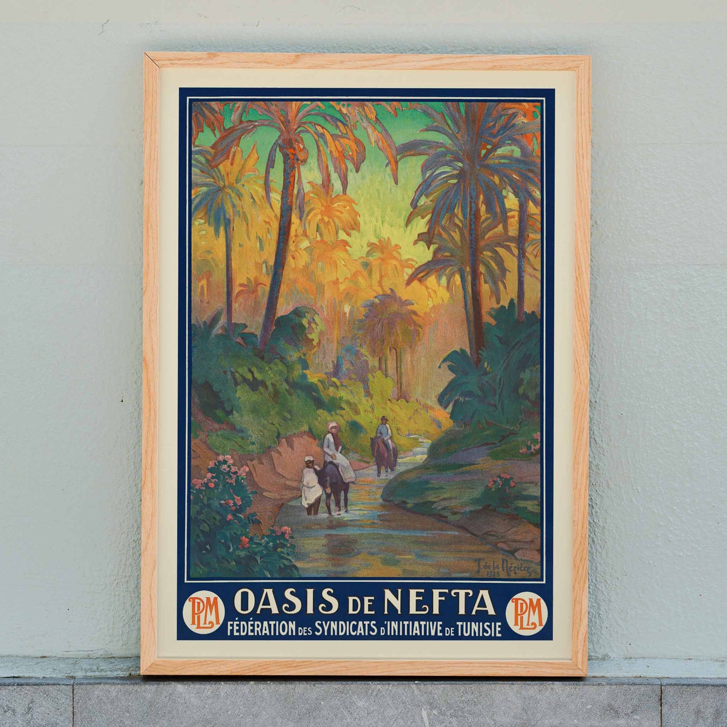 Oasis de Nefta poster by Joseph de La Nézière with lush palm oasis, warm sunset light, figures and winding stream, framed and displayed in home decor