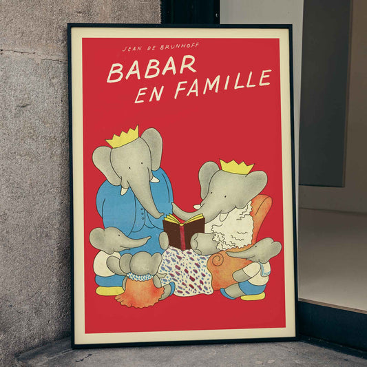 Elephant family illustration and poster from Babar en famille by Jean de Brunhoff with red background and family reading theme, framed and displayed in home decor