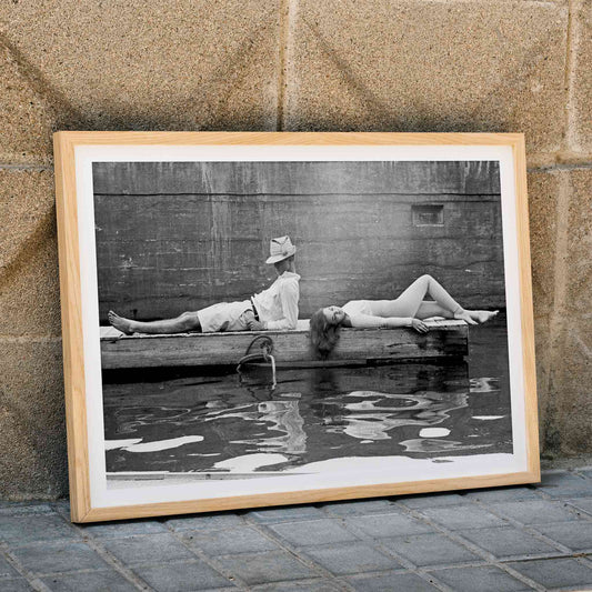 Marquess of Tavistock Henry Robin Ian Russell and Henrietta Tiarks relaxing on a dock in Bermuda by Toni Frissell poster, framed and displayed in home decor