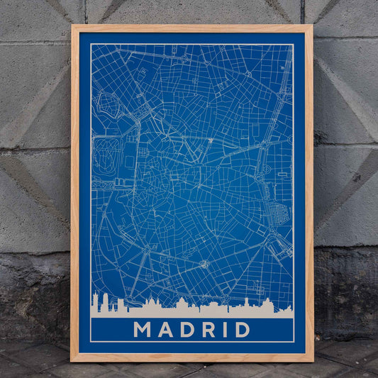 Minimalist Madrid Map by Artist Name blue and white city layout with silhouettes and street details poster, framed and displayed in home decor