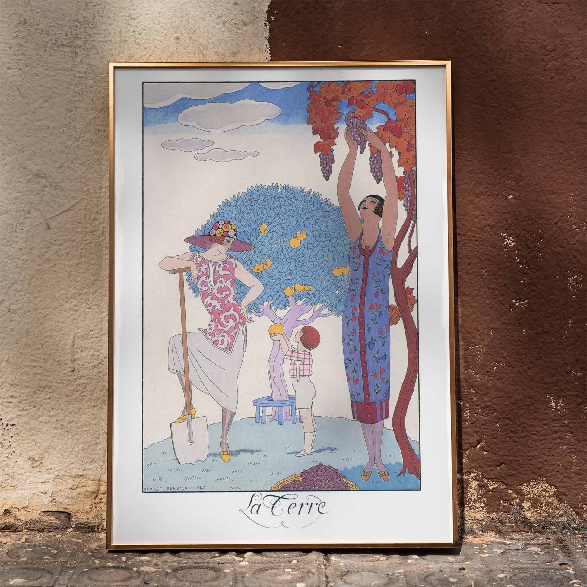 Art Deco illustration and poster by George Barbier featuring women and a child harvesting fruit in a colorful stylized garden, framed and displayed in home decor
