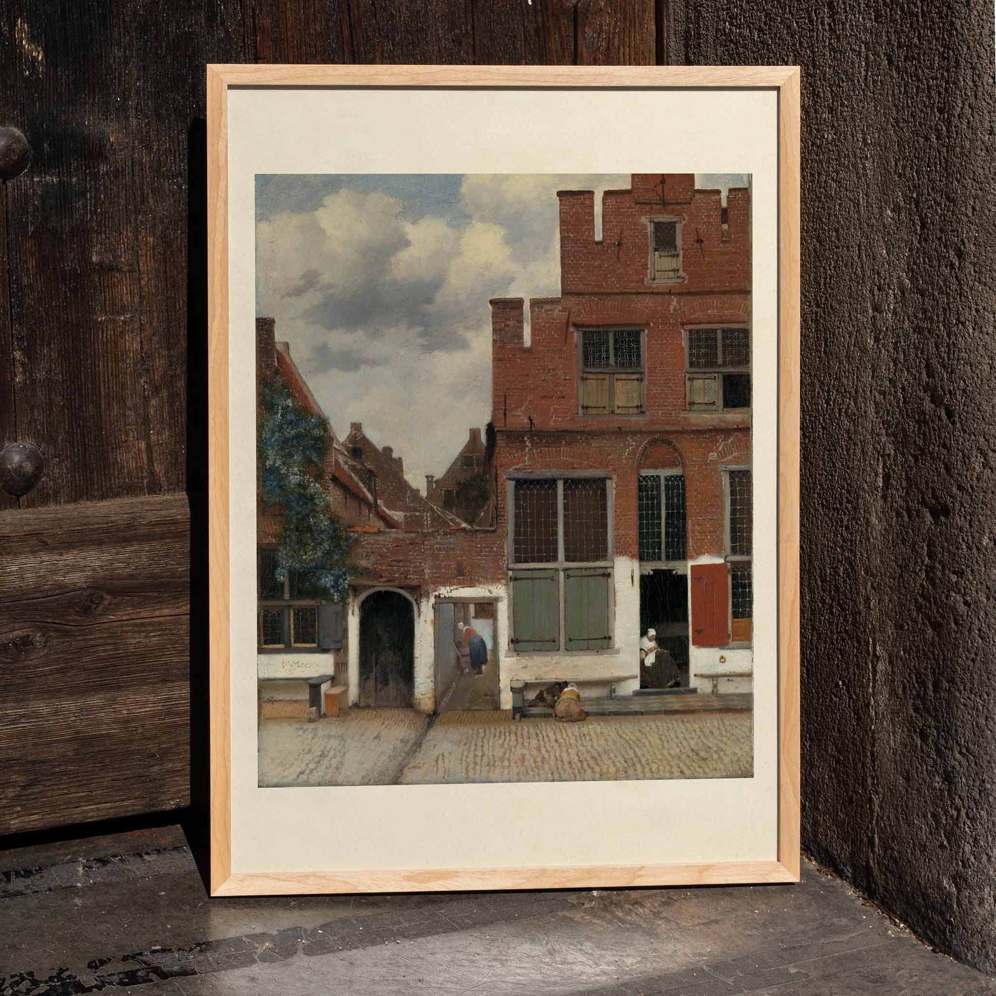 Poster of a charming street scene with brick houses and figures from View of Houses in Delft The Little Street by Johannes Vermeer, framed and displayed in home decor
