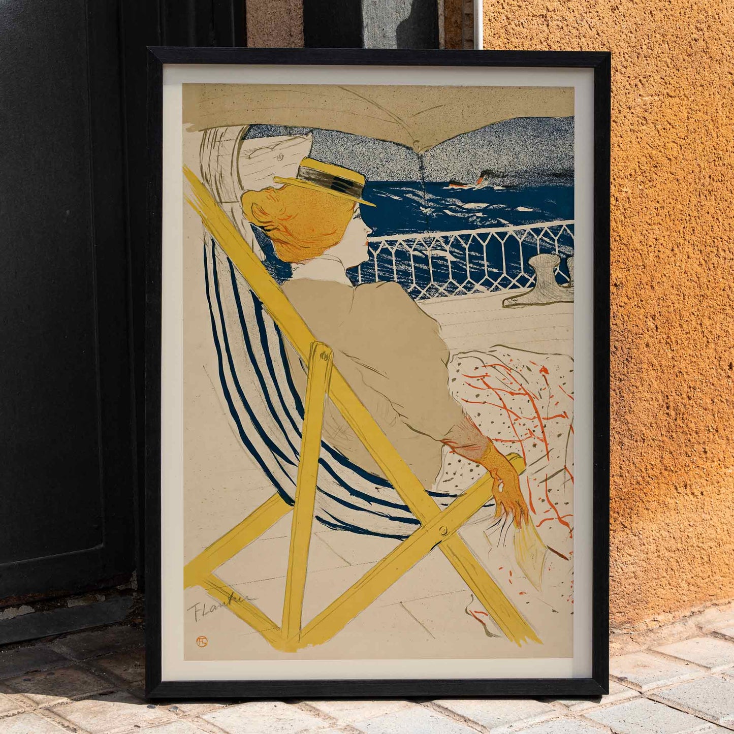 Henri de Toulouse-Lautrec La passagère du 54 poster with seated woman on deck blue sea striped chair and yellow accents, framed and displayed in home decor