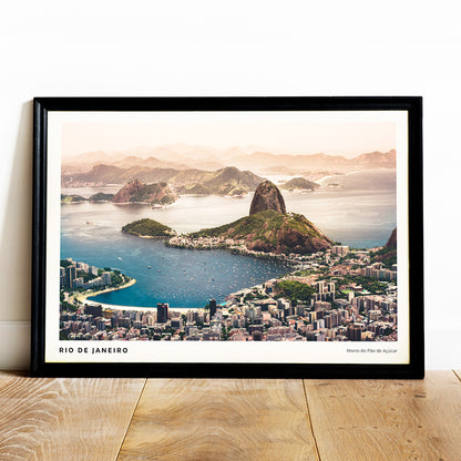 Aerial view of Rio de Janeiro with beaches buildings boats blue waters and mountains including Morro do Pao de Acucar poster artwork, framed and displayed in home decor