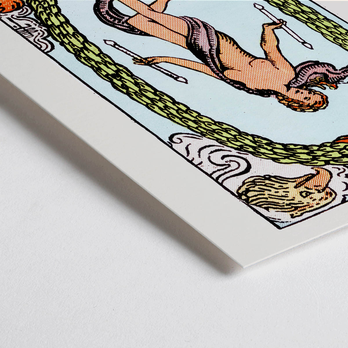 Closeup detail of The World Tarot card by Rider Waite showing a central figure within an oval wreath surrounded by four figures representing the fixed signs