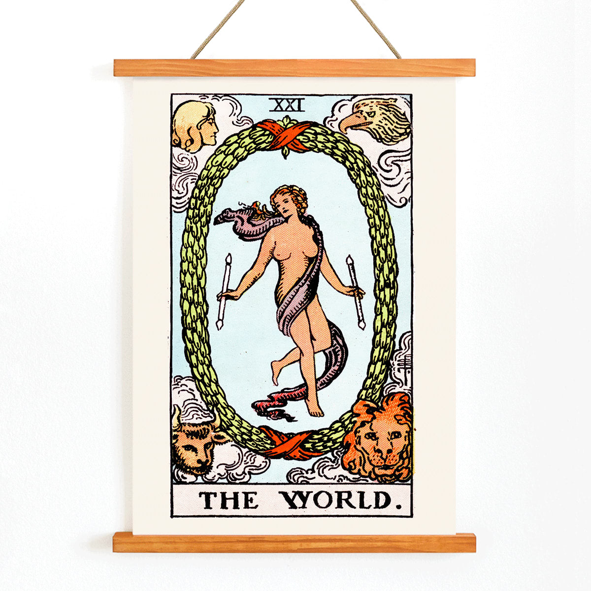 The World Tarot card by Rider Waite showing a central figure within an oval wreath surrounded by four figures representing the fixed signs, with wooden magnetic frame on white background