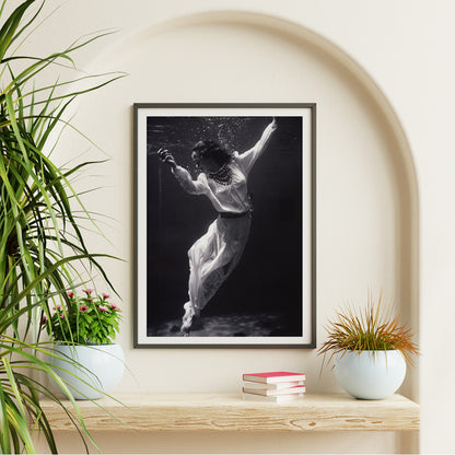 Black and white artwork of a fashion model floating underwater in dolphin tank Marineland Florida by Toni Frissell, framed and displayed in home decor