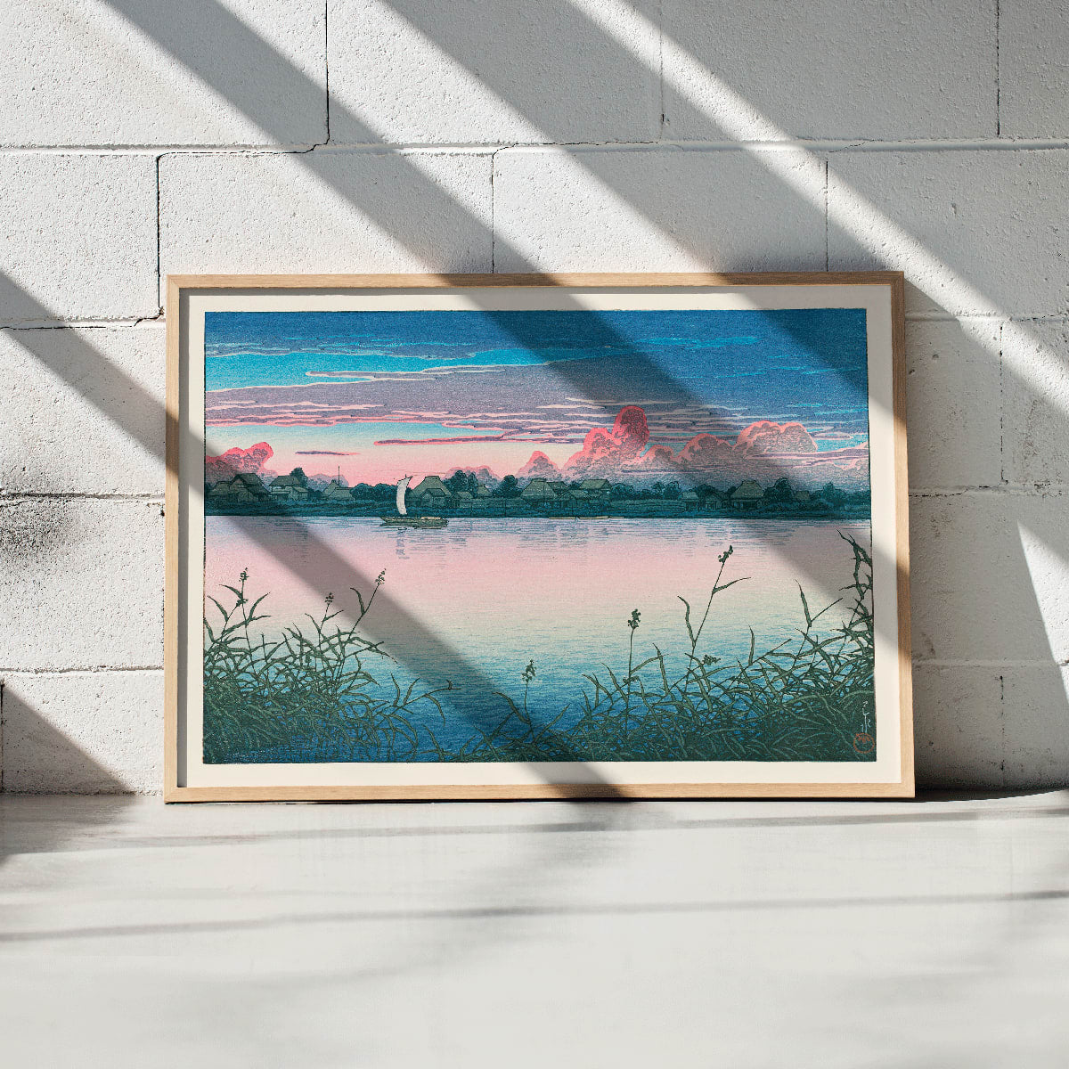 Early Autumn in Urayasu by Kawase Hasui peaceful lakeside village poster with serene waterfront houses boat and colorful sky, framed and displayed in modern living room decor